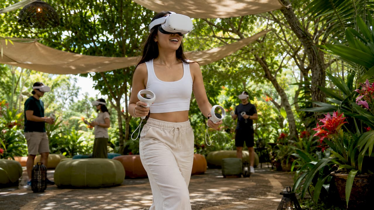 Woman exploring immersive VR arcade space