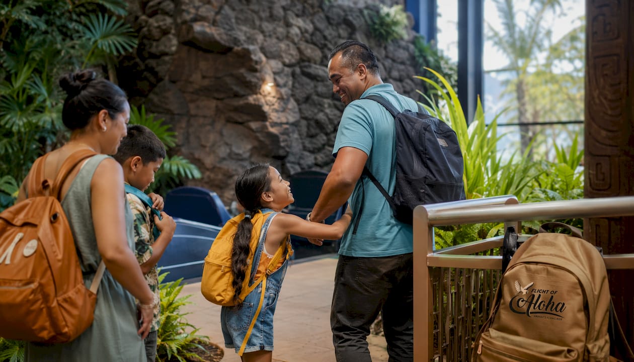 Families preparing for flying-theater ride