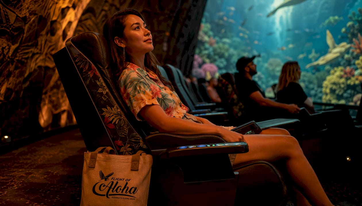 Young woman seated inside flying theater simulator