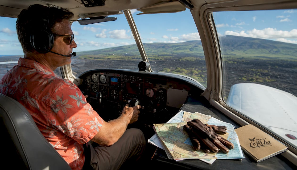 Pilot in fixed-wing plane cockpit at Kauai airport