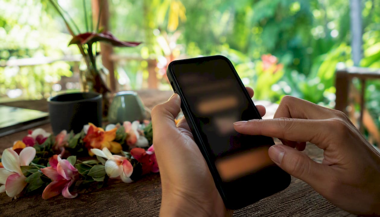 Finger redeeming Flight of Aloha voucher on phone
