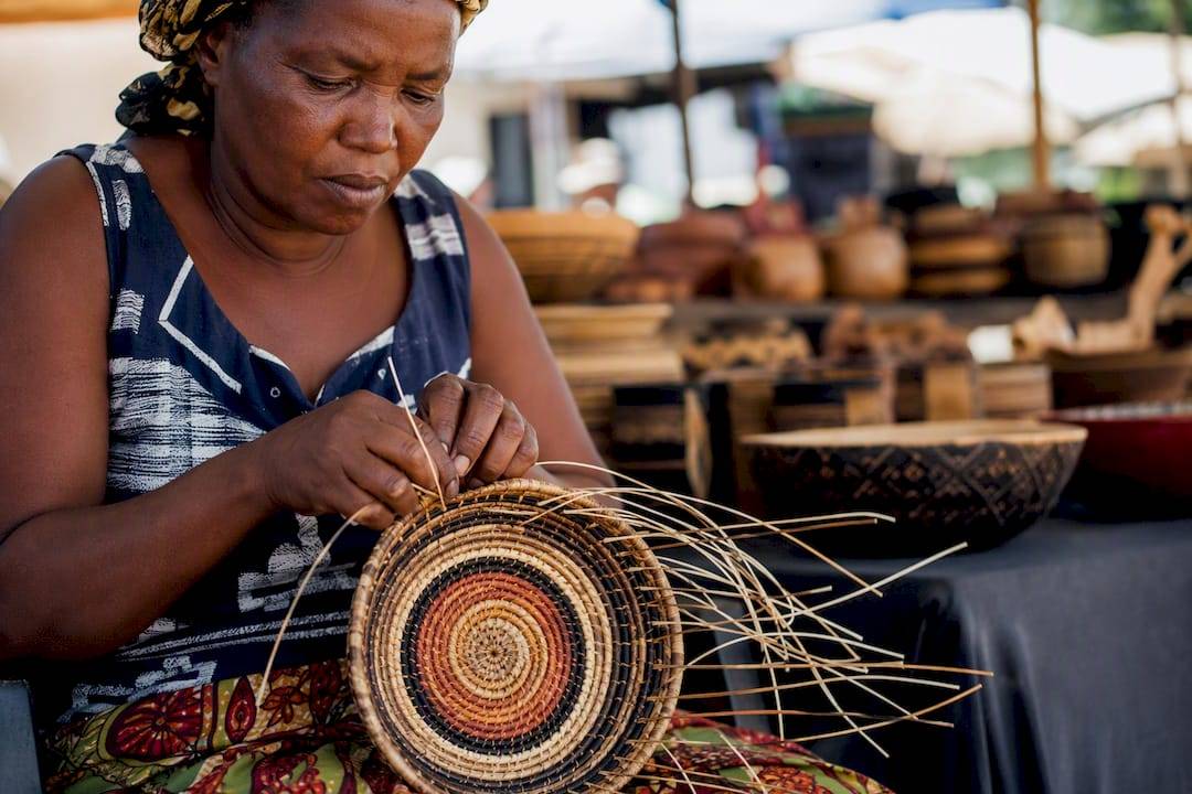 Hands weaving basket at African market