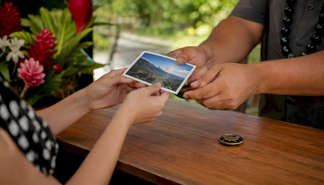 Hands exchanging souvenir photo and pin