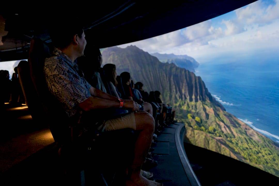 Riders facing Hawaii imagery in flying theater