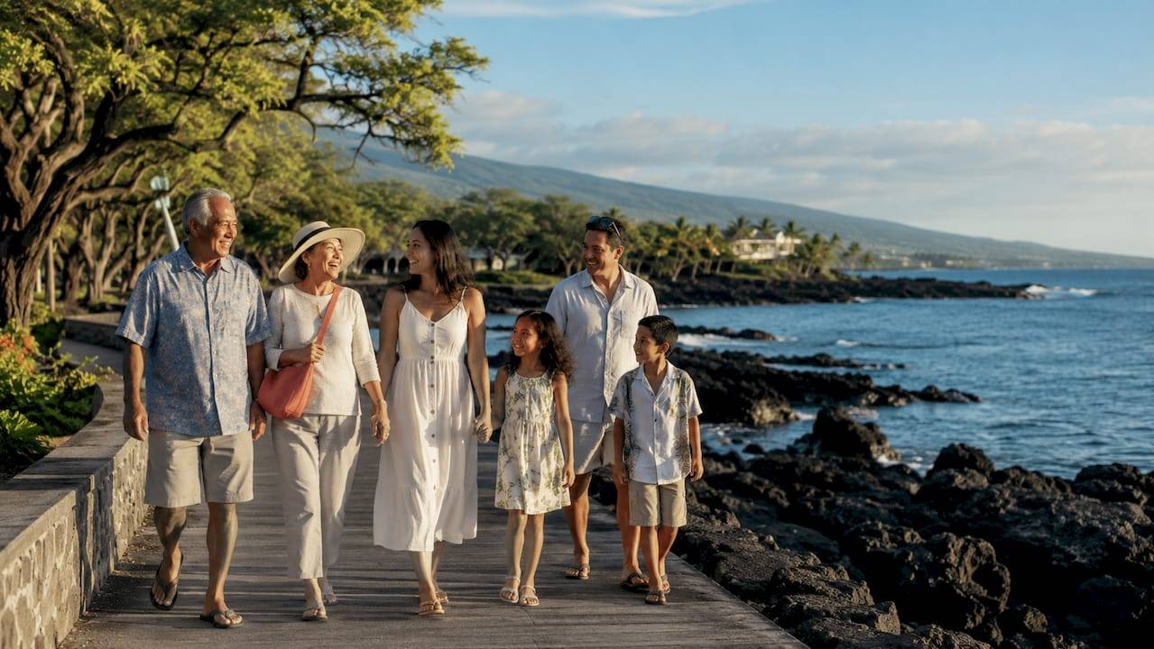 Family walking along Kailua Kona shoreline