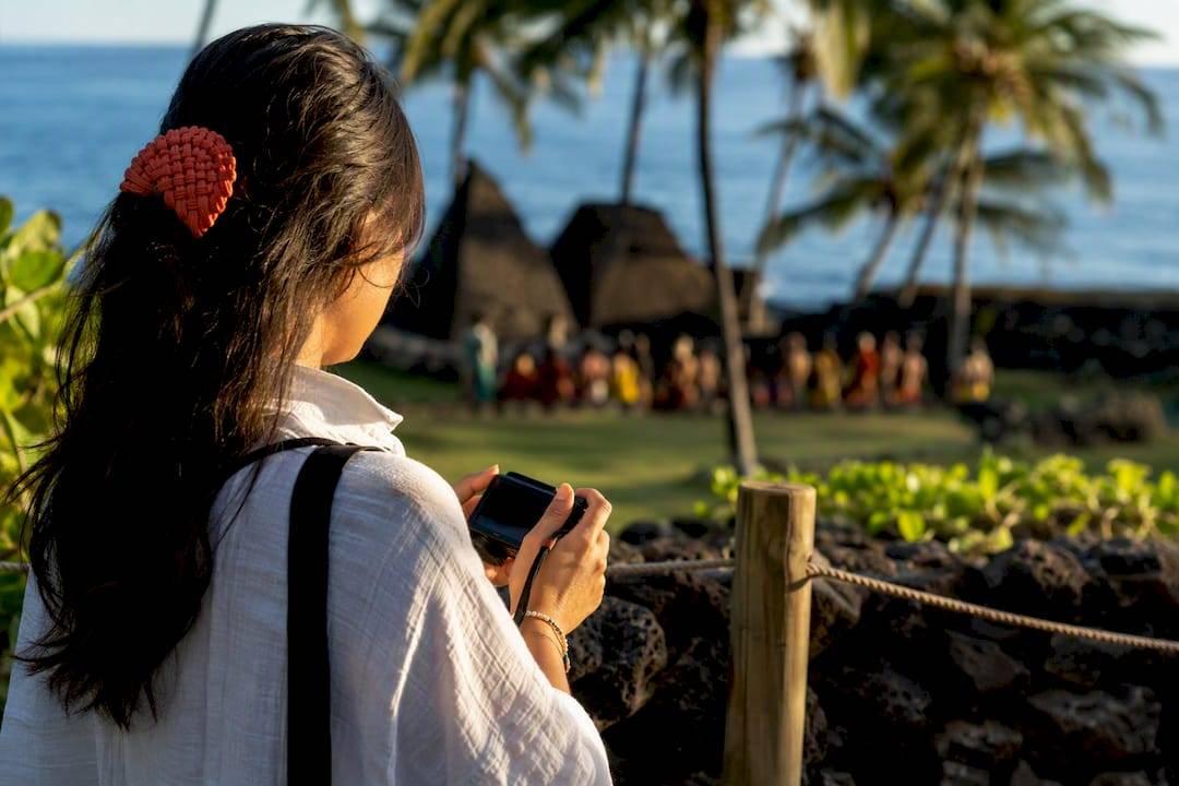 Visitor respectfully observing Hawaiian cultural site