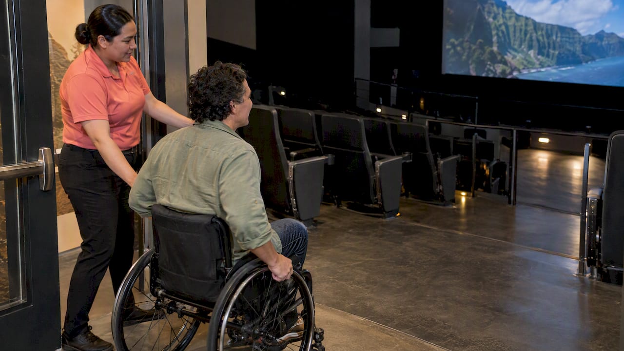 Wheelchair user entering accessible theater seating