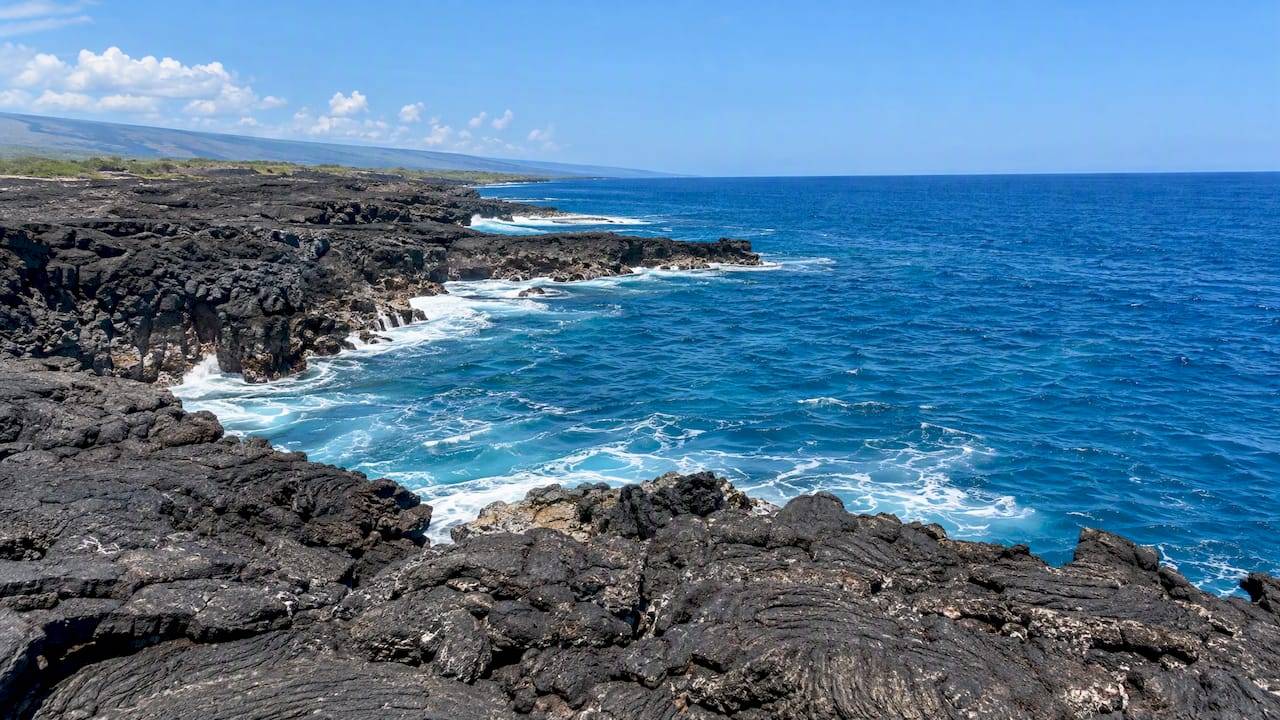 Dark lava coastline meets the Pacific