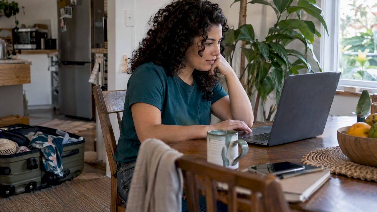 Traveler comparing flight payment options at home