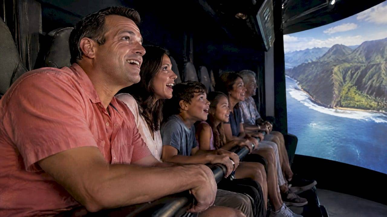 Group reacting together inside a Hawaiian flying theater