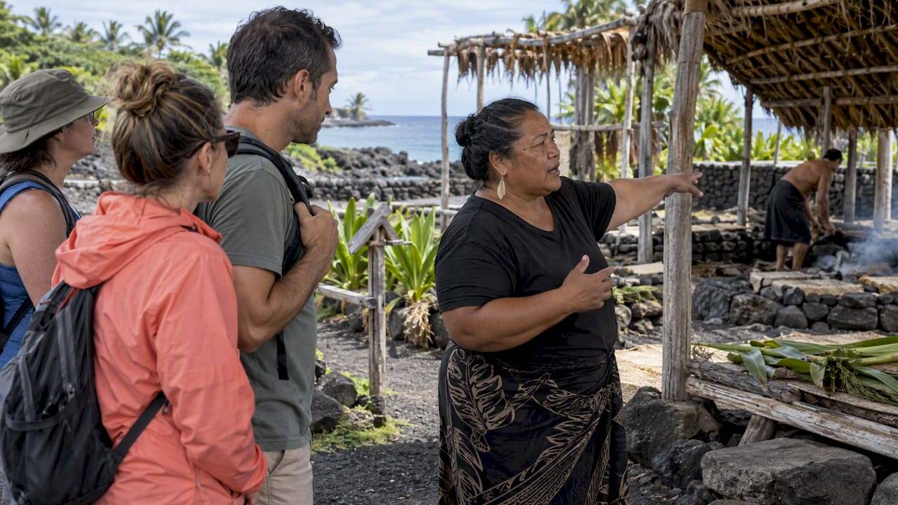 Traveler asking a local guide about community benefit